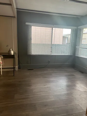 a view of room with window and hardwood floor