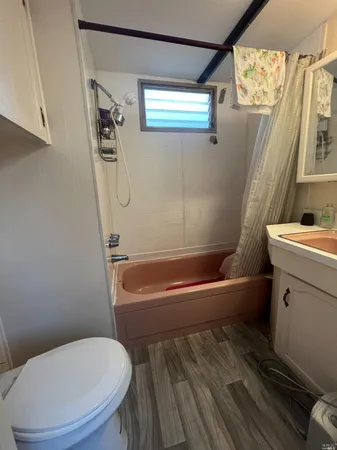 a bathroom with a toilet and a bathtub