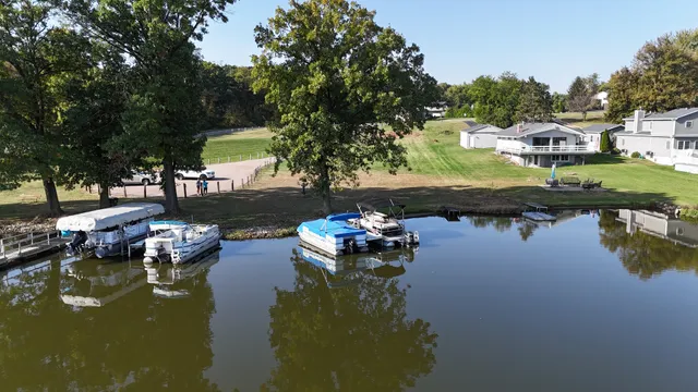 a water view with boat and trees in the background