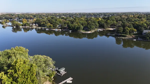 a view of a lake with boats and trees in the background