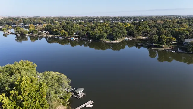 a view of a lake with boats and trees in the background