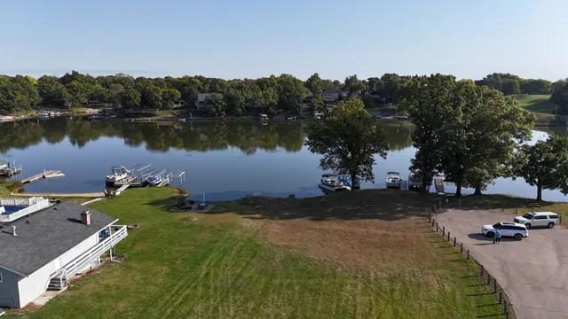 an aerial view of a house with garden space and lake view