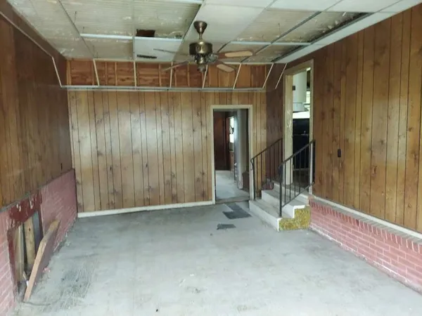 a view of a room with wooden floor and door