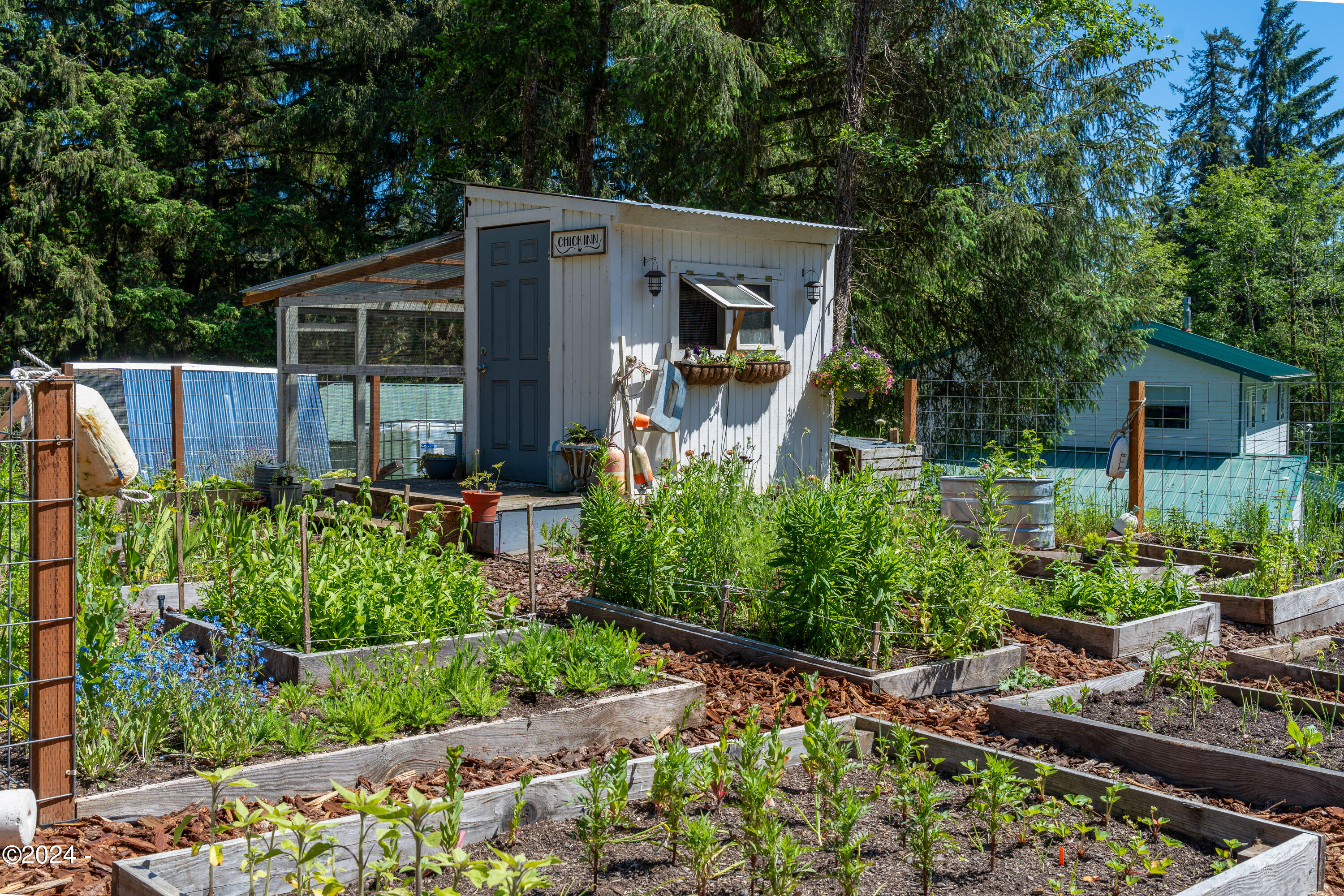 405 Southeast John Nye Road Newport, OR 97365 - Photo 35 of 54 Chicken coop & raised beds