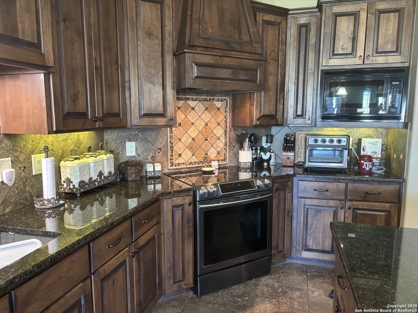 104 Park View Poth, TX 78147 - Photo 11 of 54 a kitchen with stainless steel appliances granite countertop a stove and cabinets