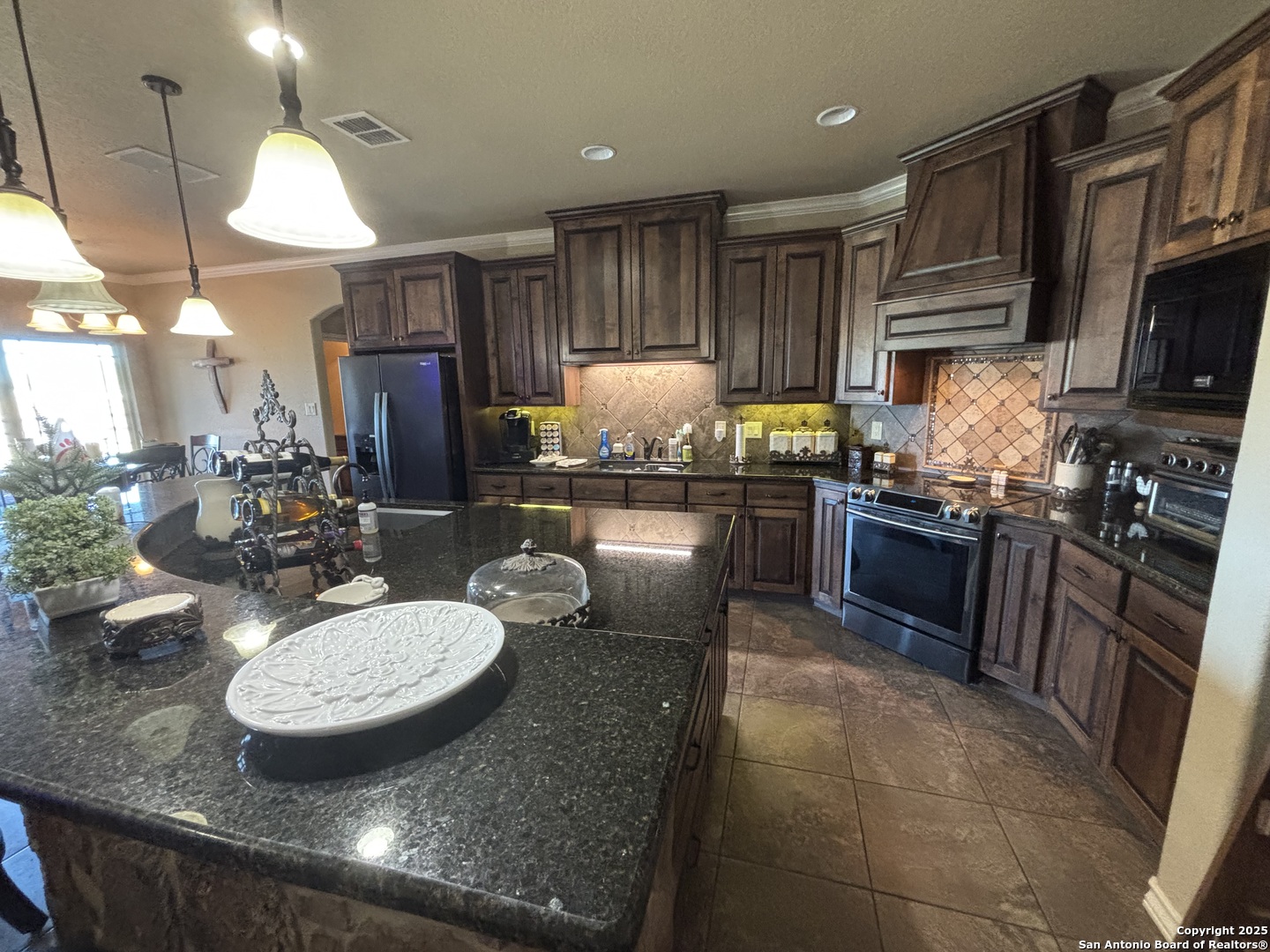 104 Park View Poth, TX 78147 - Photo 13 of 54 a kitchen with stainless steel appliances granite countertop a stove top oven a sink a dining table and chairs