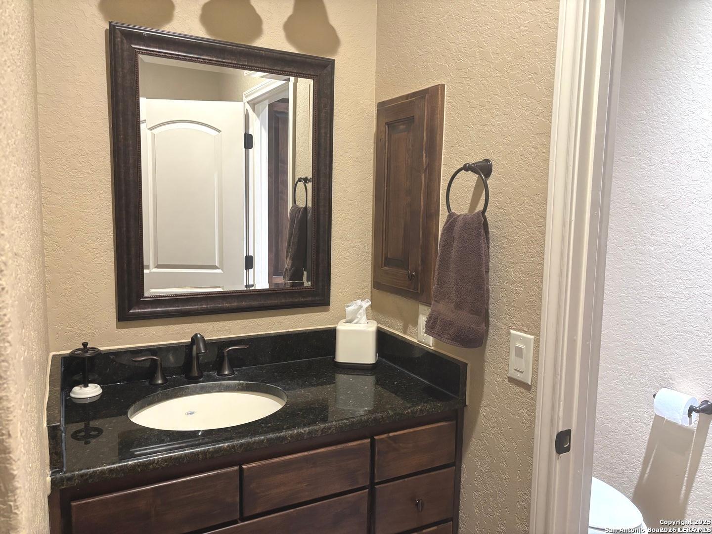 104 Park View Poth, TX 78147 - Photo 25 of 54 a bathroom with a granite countertop sink and a mirror