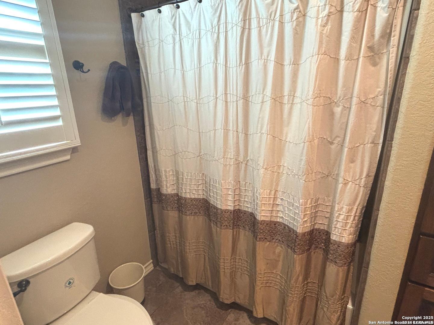104 Park View Poth, TX 78147 - Photo 28 of 54 a bathroom with a toilet and a shower curtain