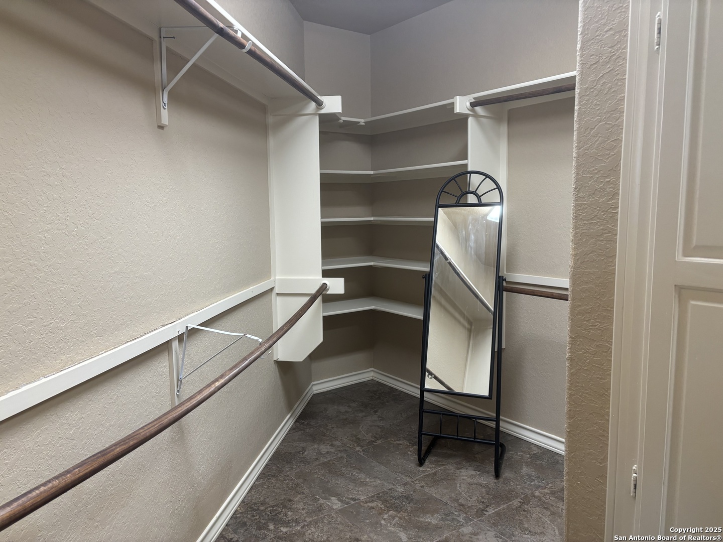 104 Park View Poth, TX 78147 - Photo 29 of 54 a room with walk in closet and wooden floor