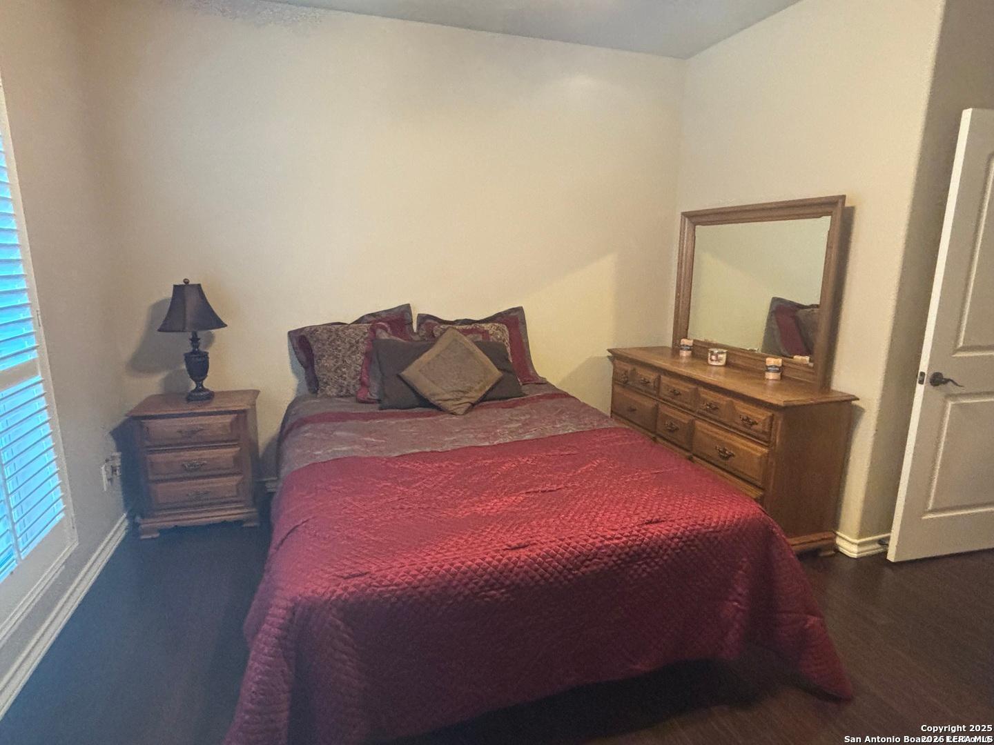 104 Park View Poth, TX 78147 - Photo 30 of 54 a bedroom with a bed and wooden floor