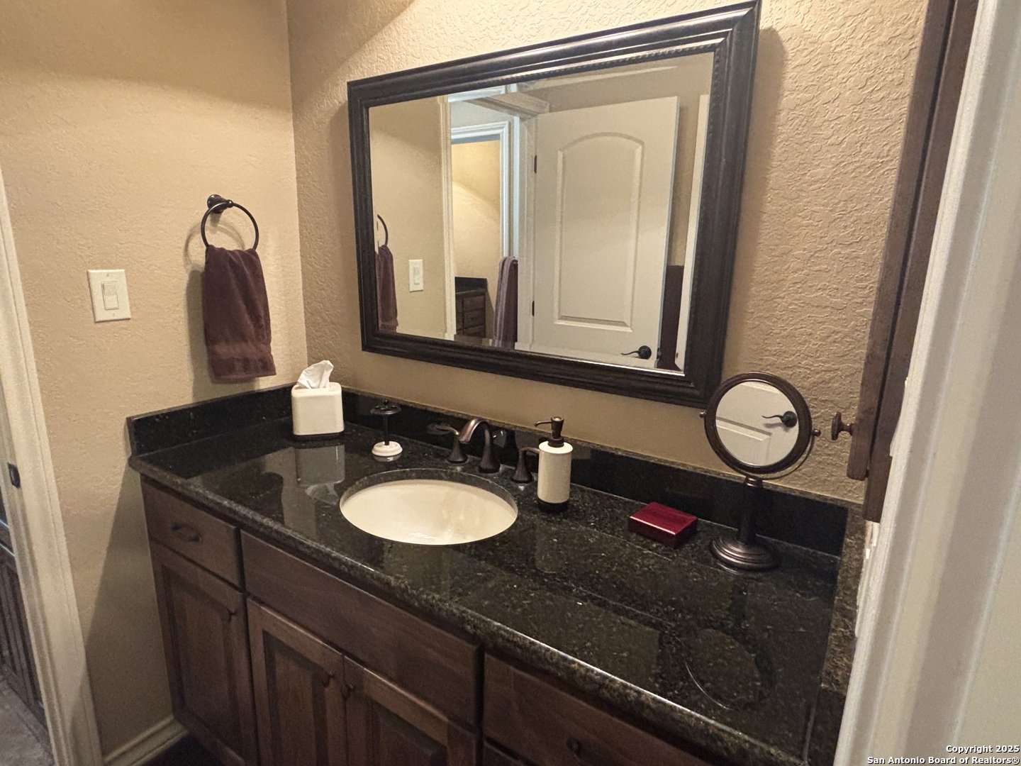 104 Park View Poth, TX 78147 - Photo 36 of 54 a bathroom with a granite countertop sink a mirror and a shower