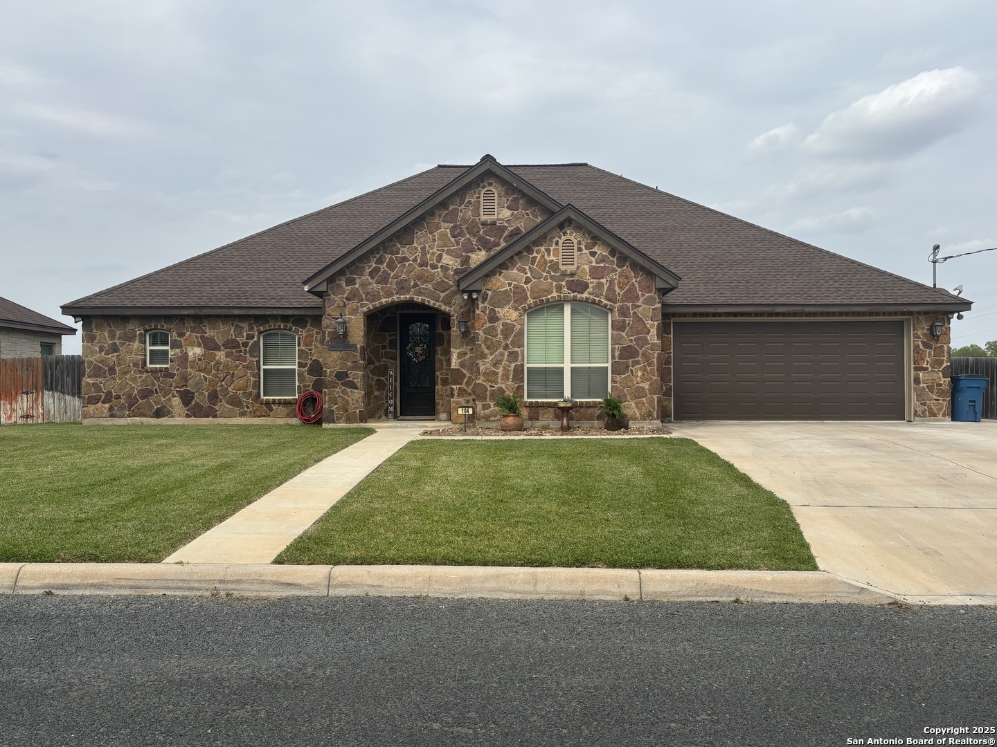 104 Park View Poth, TX 78147 - Photo 4 of 54 a front view of a house with a garden and plants