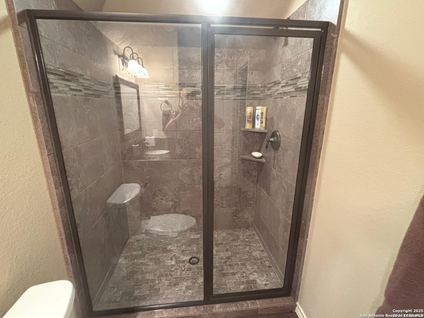 104 Park View Poth, TX 78147 - Photo 46 of 54 a bathroom with a glass shower door