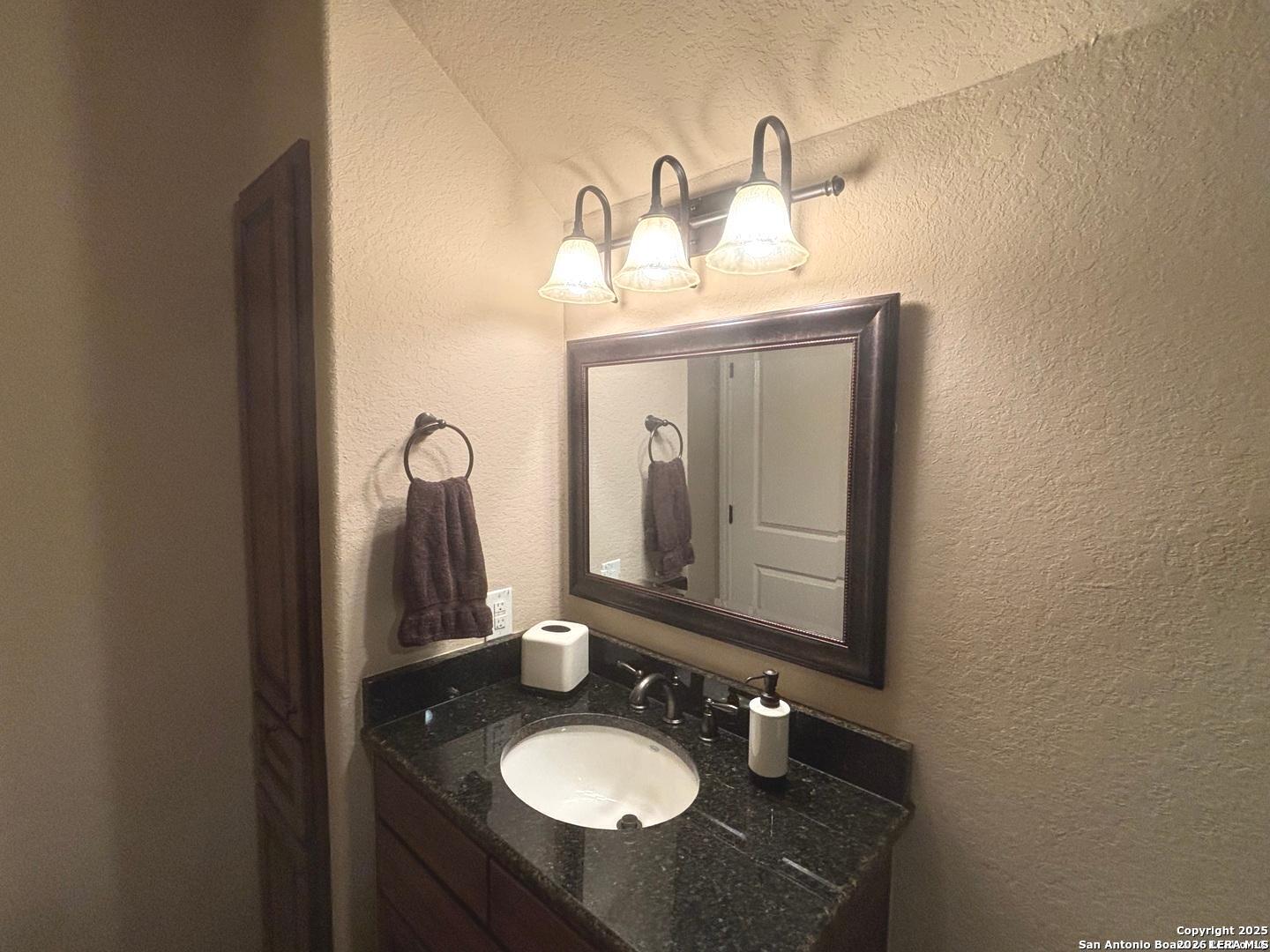 104 Park View Poth, TX 78147 - Photo 48 of 54 a bathroom with a sink vanity and mirror