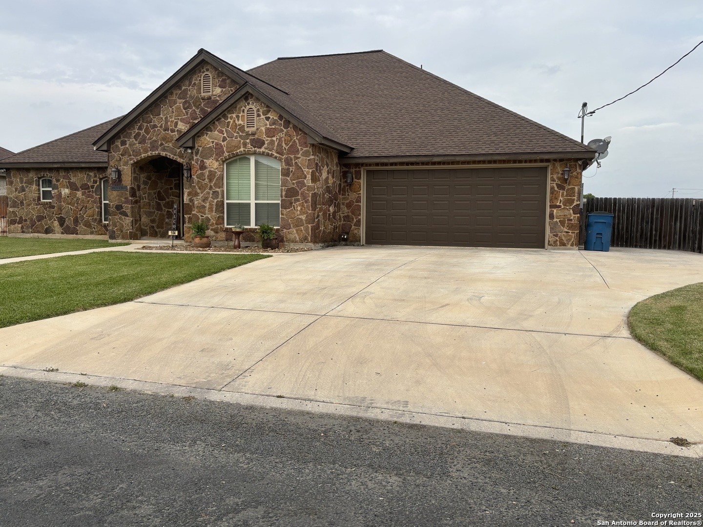 104 Park View Poth, TX 78147 - Photo 5 of 54 a front view of a house with a yard and garage