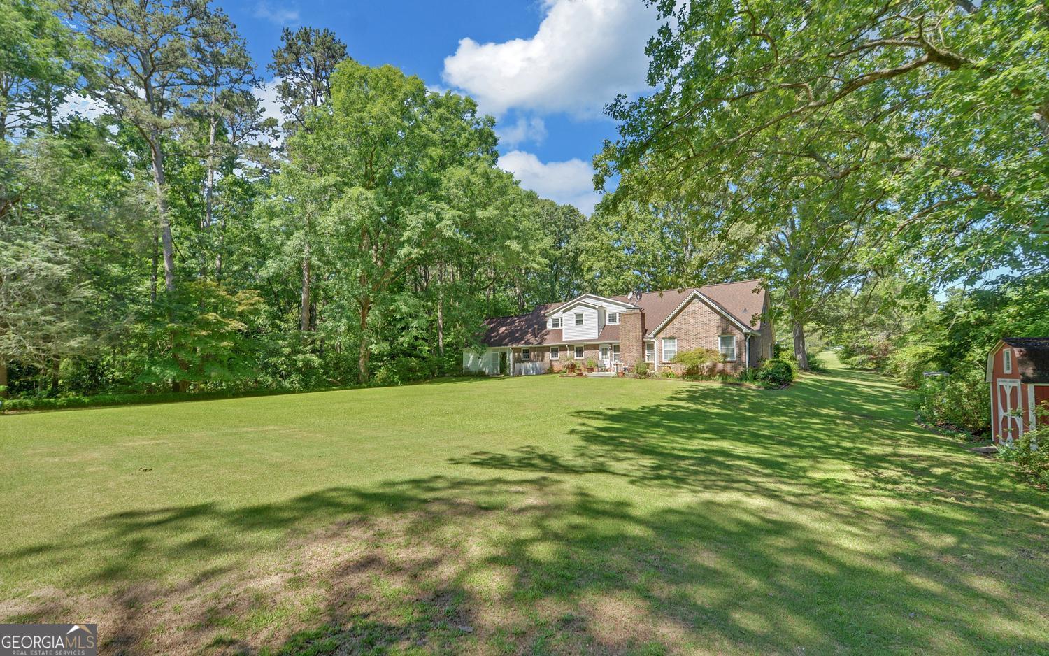 400 Harris Street Toccoa, GA 30577 - Photo 41 of 49 a backyard of a house with lots of green space and fountain