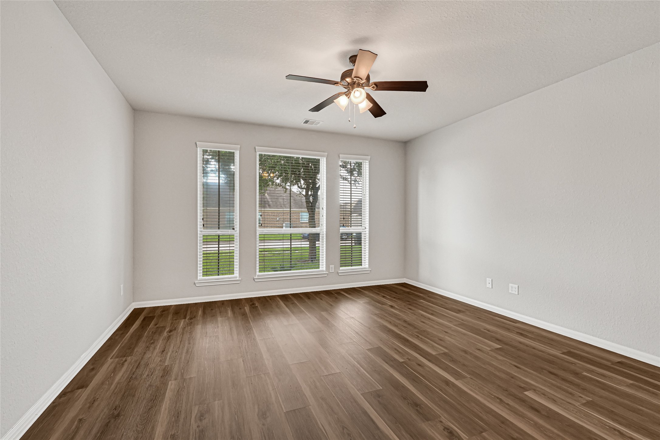 5331 Seabird Street Baytown, TX 77521 - Photo 21 of 38 a view of wooden floor and windows in a room