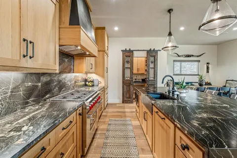 a kitchen with sink stove and cabinets