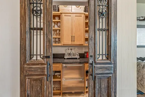 a kitchen with a refrigerator and cabinets