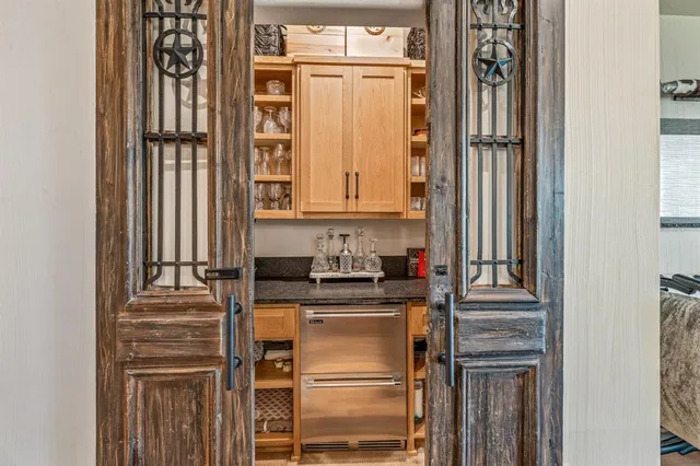 a kitchen with a refrigerator and cabinets