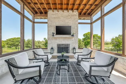 a living room with patio furniture and a fireplace