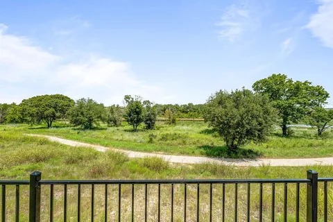 a view of a green field with lots of bushes