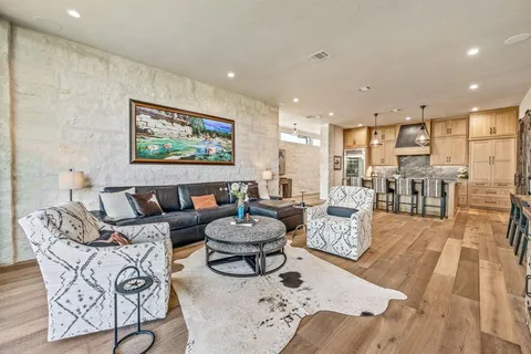 a living room with furniture and a view of kitchen