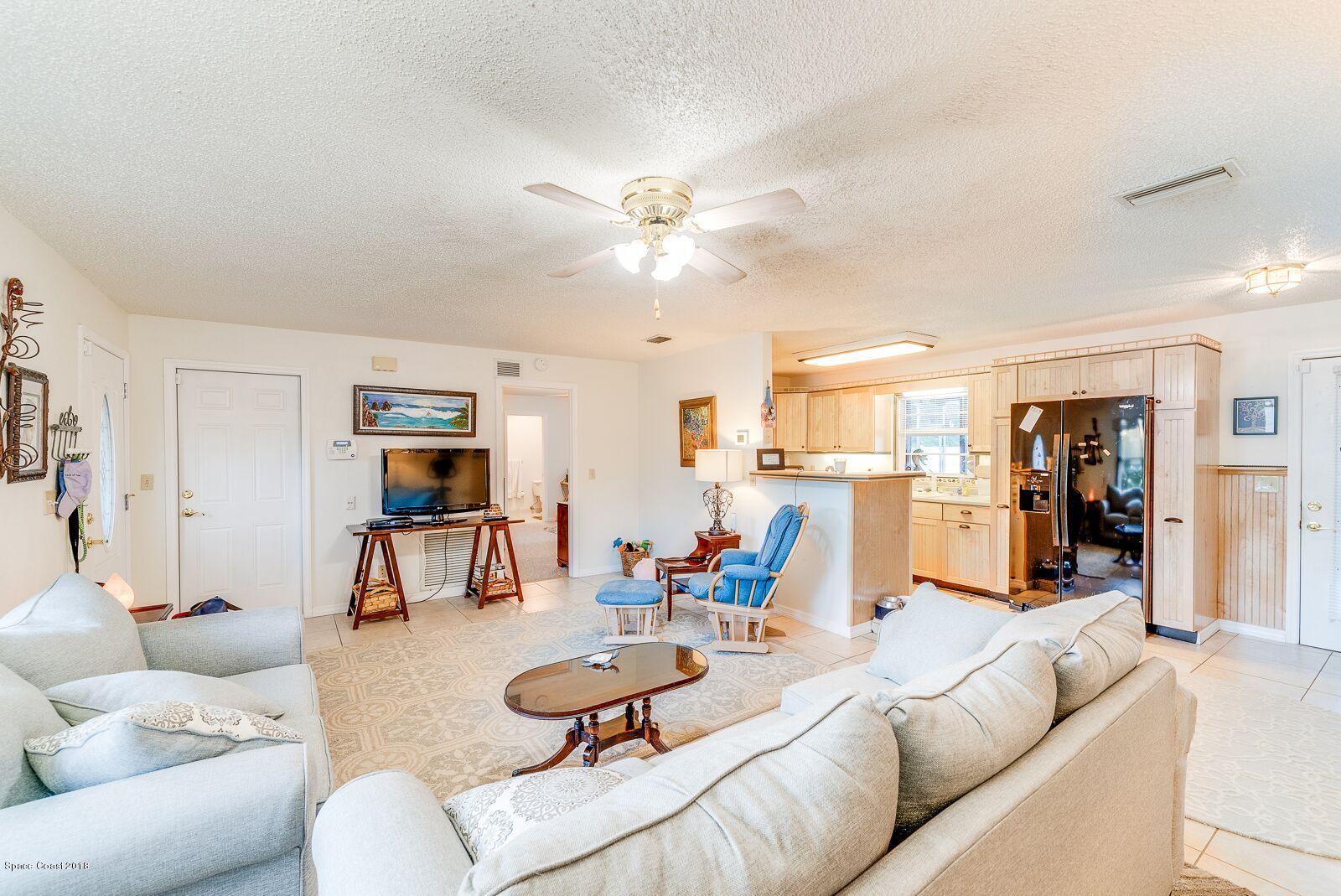 939 Raleigh Road Southeast Palm Bay, FL 32909 - Photo 10 of 30 LLV KITCHEN LIVING ROOM