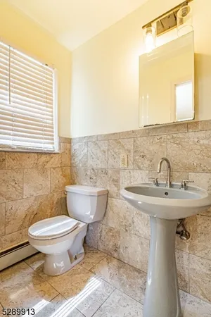 a bathroom with a sink toilet and mirror