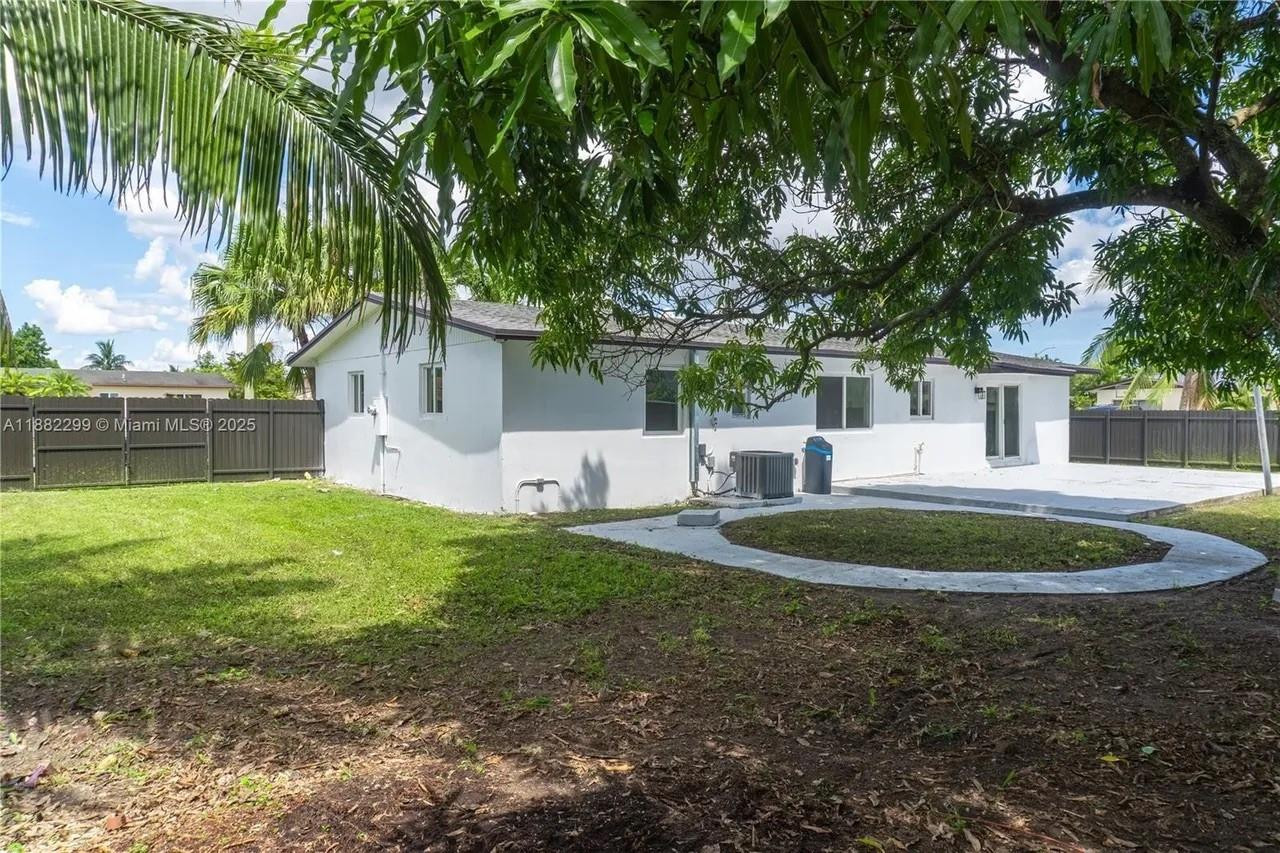 11872 Southwest 196th Terrace Miami, FL 33177 - Photo 2 of 15 a backyard of a house with table and chairs