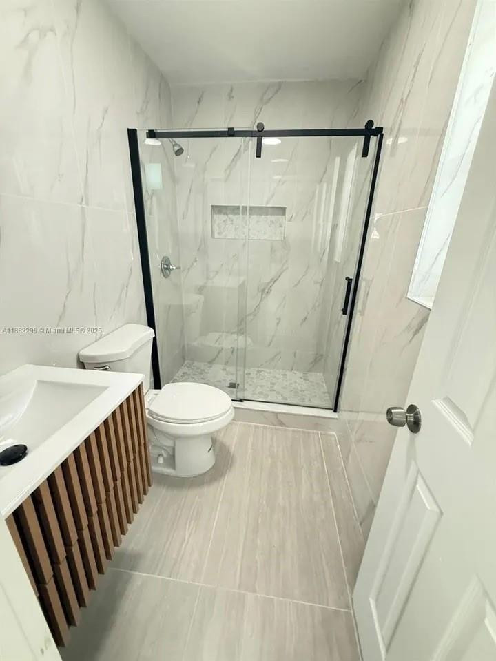 11872 Southwest 196th Terrace Miami, FL 33177 - Photo 4 of 15 a bathroom with a sink toilet and shower