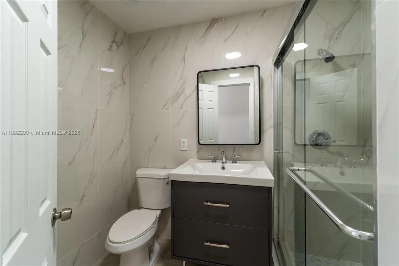 11872 Southwest 196th Terrace Miami, FL 33177 - Photo 10 of 15 a bathroom with a toilet sink shower and mirror