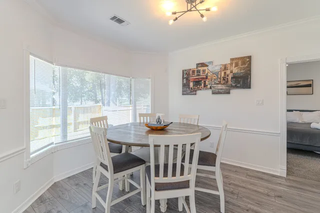a view of a dining room with furniture and wooden floor