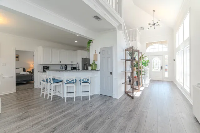 a living room with furniture dining table and wooden floors