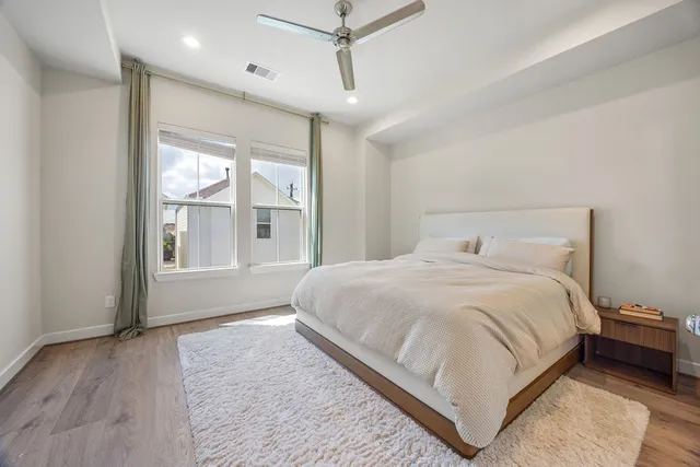 a large bed sitting in a room next to a window