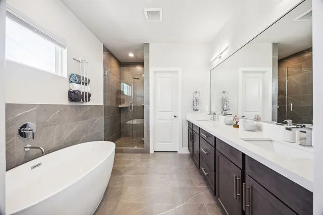 a spacious bathroom with a double vanity sink mirror double and bathtub