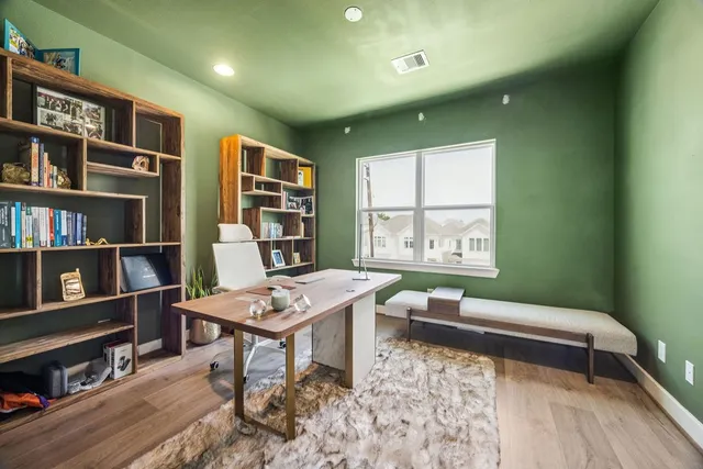 a living room with furniture and a book shelf