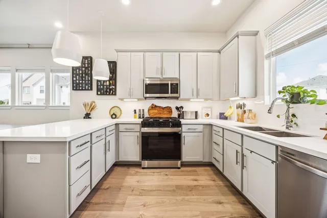 a kitchen with granite countertop a sink and a stove top oven