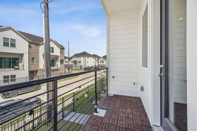 a view of a brick house with a balcony