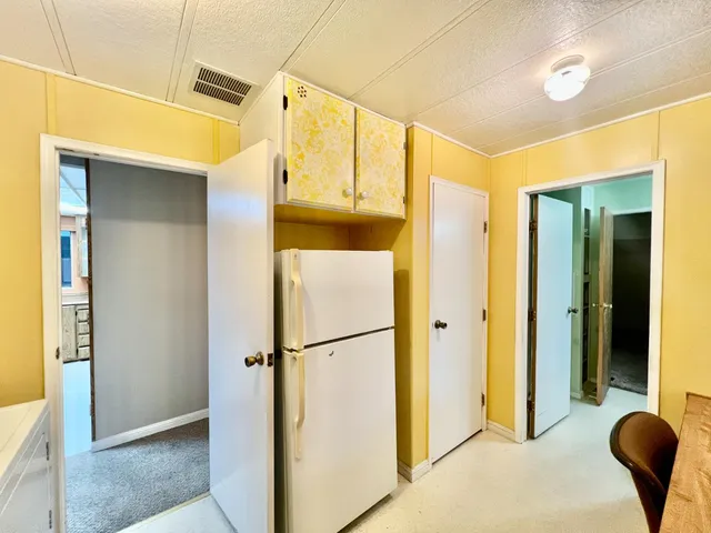 a view of hallway with furniture and a shower