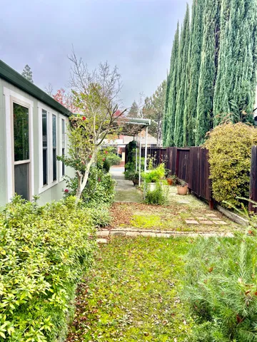 a view of a house with a yard and plants