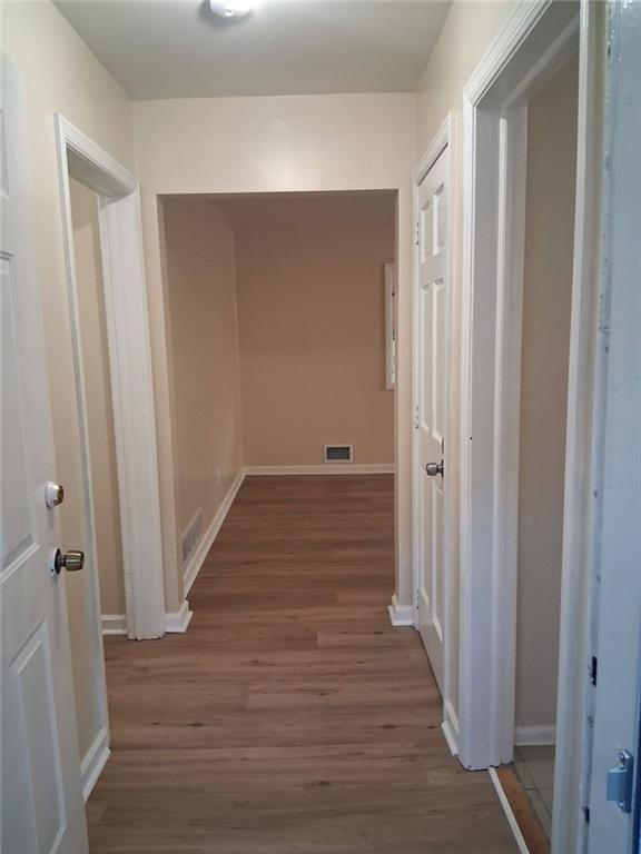 1915 Wee Kirk Road Southeast Atlanta, GA 30316 - Photo 6 of 23 a view of a room with wooden floor and entryway