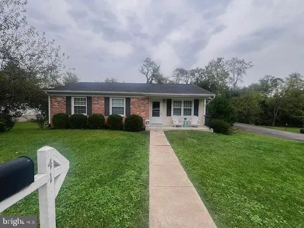 a front view of a house with a yard table and chairs