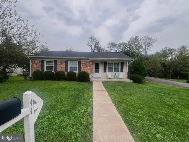 a front view of a house with a yard table and chairs