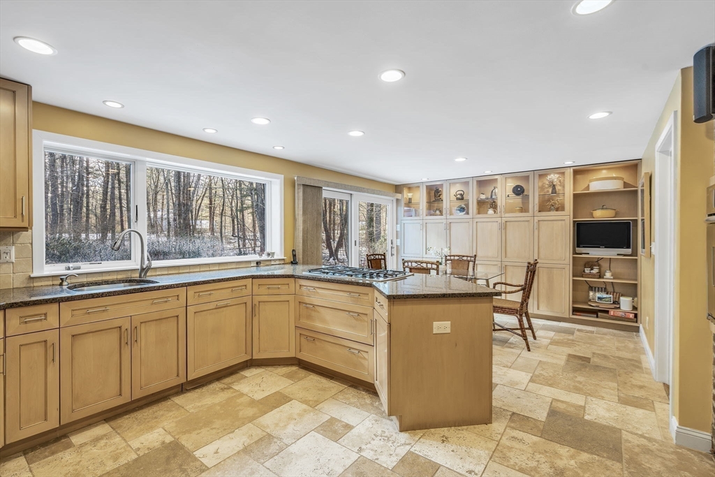 19 Sears Road Wayland, MA 01778 - Photo 13 of 42 a large kitchen with lots of counter space and dining table