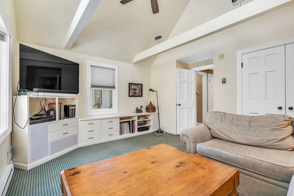 19 Sears Road Wayland, MA 01778 - Photo 19 of 42 a living room with furniture flat screen tv and kitchen view