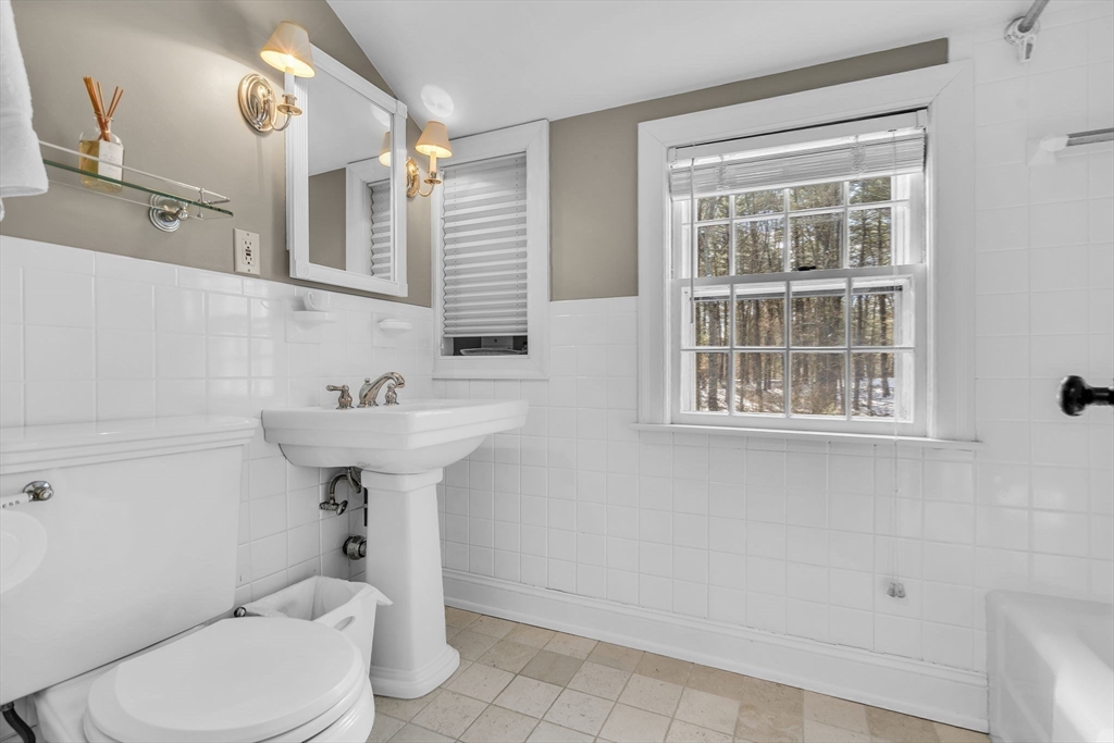 19 Sears Road Wayland, MA 01778 - Photo 29 of 42 a bathroom with a sink a toilet and mirror