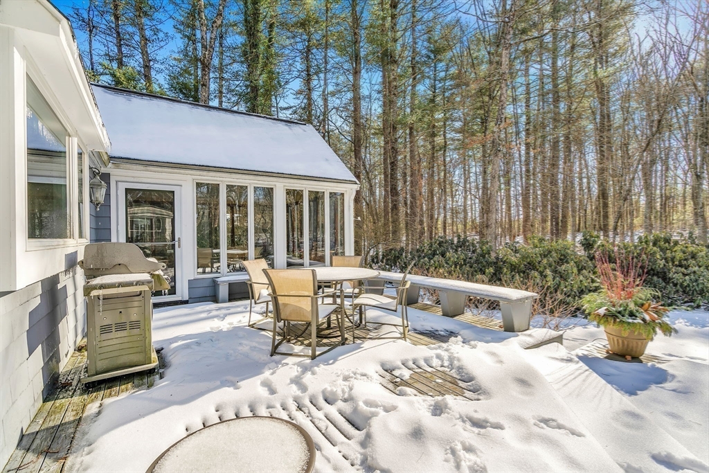 19 Sears Road Wayland, MA 01778 - Photo 39 of 42 a view of a patio with a dining table and chairs with wooden fence