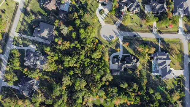 an aerial view of a house a yard and mountain view in back