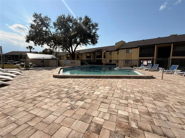 a swimming pool view with a outdoor seating